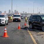 Emirates Road Incident near Al Ain Bridge with Dubai Police managing traffic after an accident